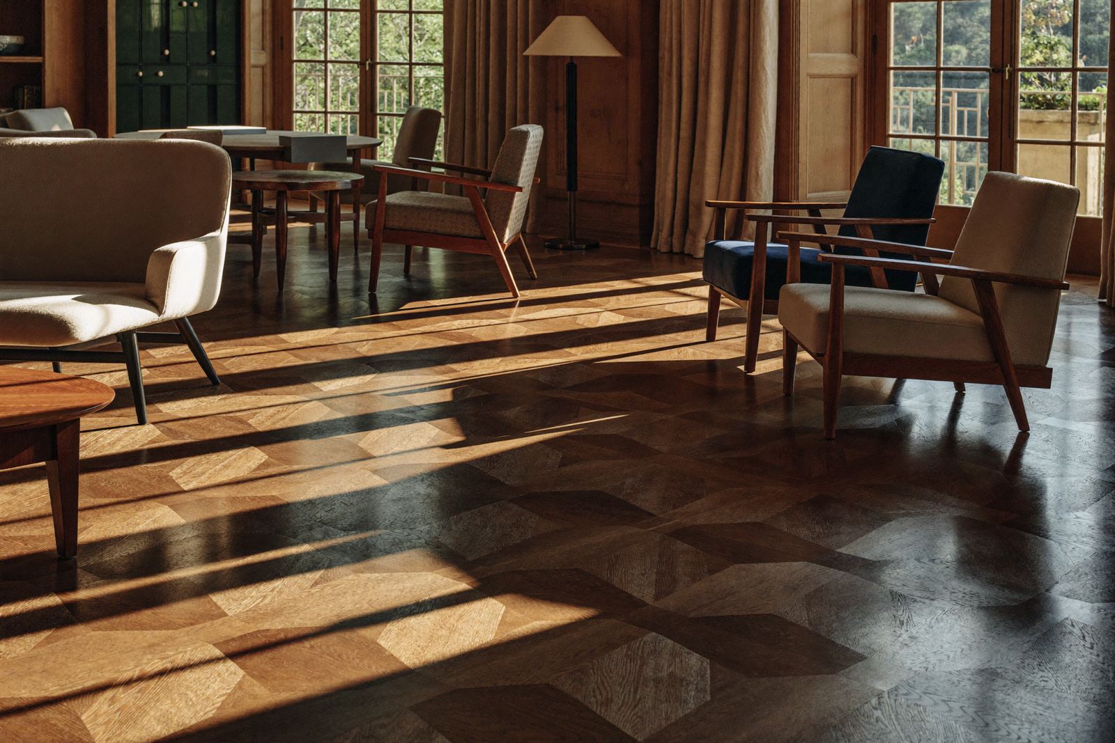 Boutique hotel interior with rich oak herringbone flooring in warm afternoon light